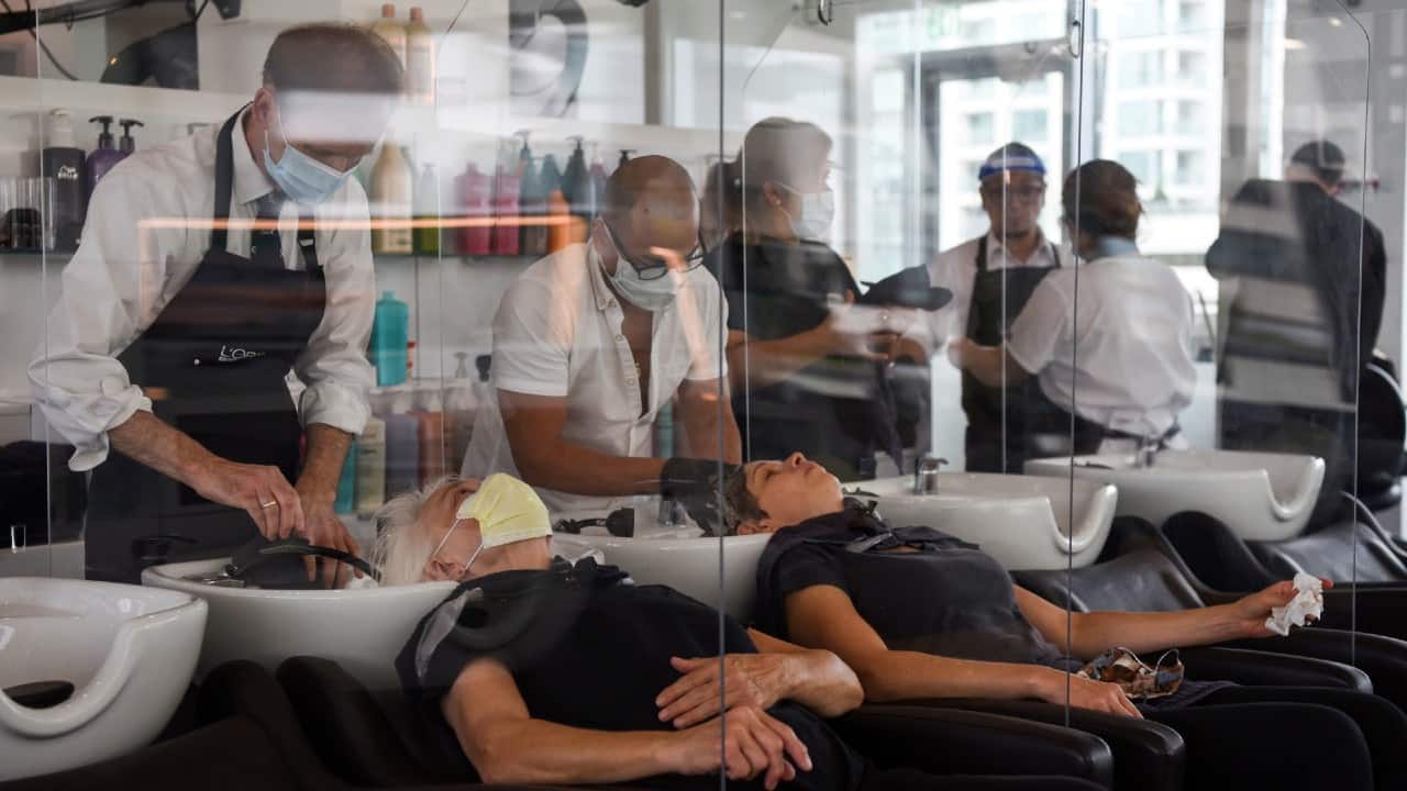 Women are separated by dividers as they have their hair washed at Bella Rinova in Houston, Texas, on May 8. (Image: Reuters) Women are separated by dividers as they have their hair washed at Bella Rinova in Houston, Texas, on May 8. (Image: Reuters)