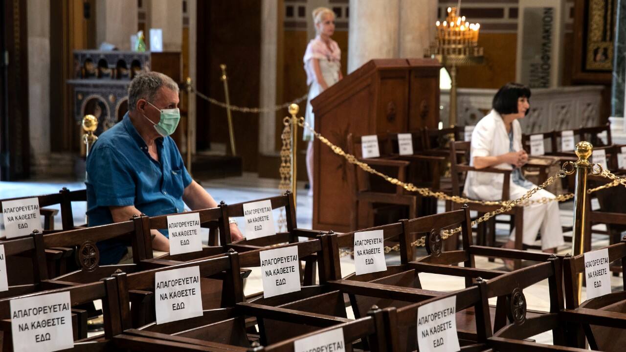 Christians attend mass inside the Athens Orthodox cathedral in Athens. The Greek government allowed churches throughout the country to reopen their doors to the faithful on May 17, a decision that applies to regular services and ceremonies like baptisms and weddings. The signs on the chairs read: "Not allowed to sit here." (Image: AP)