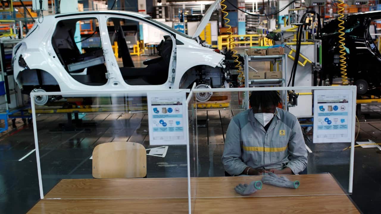 An employee, wearing a protective face mask, sits on the automobile assembly line at the Renault automobile factory in Flins, France, on May 6. (Image: Reuters) An employee, wearing a protective face mask, sits on the automobile assembly line at the Renault automobile factory in Flins, France, on May 6. (Image: Reuters)
