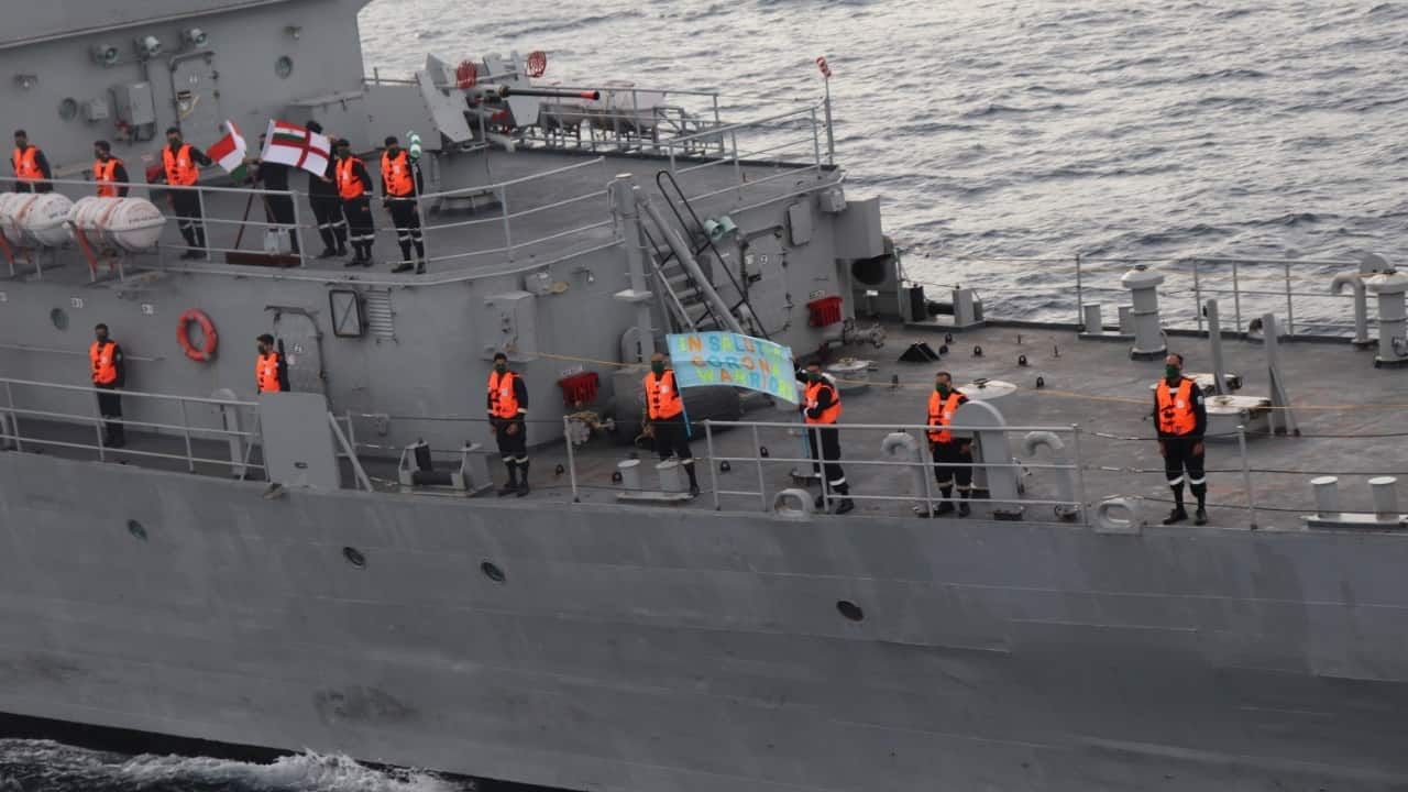 Personnel onboard INS Savitri of the Eastern Naval Command on a mission deployment, saluting India’s ‘corona warriors’. (Image: Twitter/@PRO_Vizag Defence PRO Visakhapatnam)
