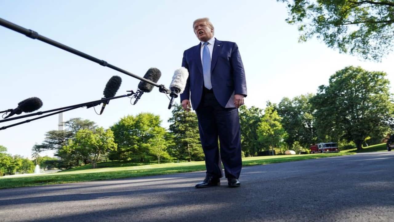 Donald Trump honors war dead in events colored by pandemic’s threat