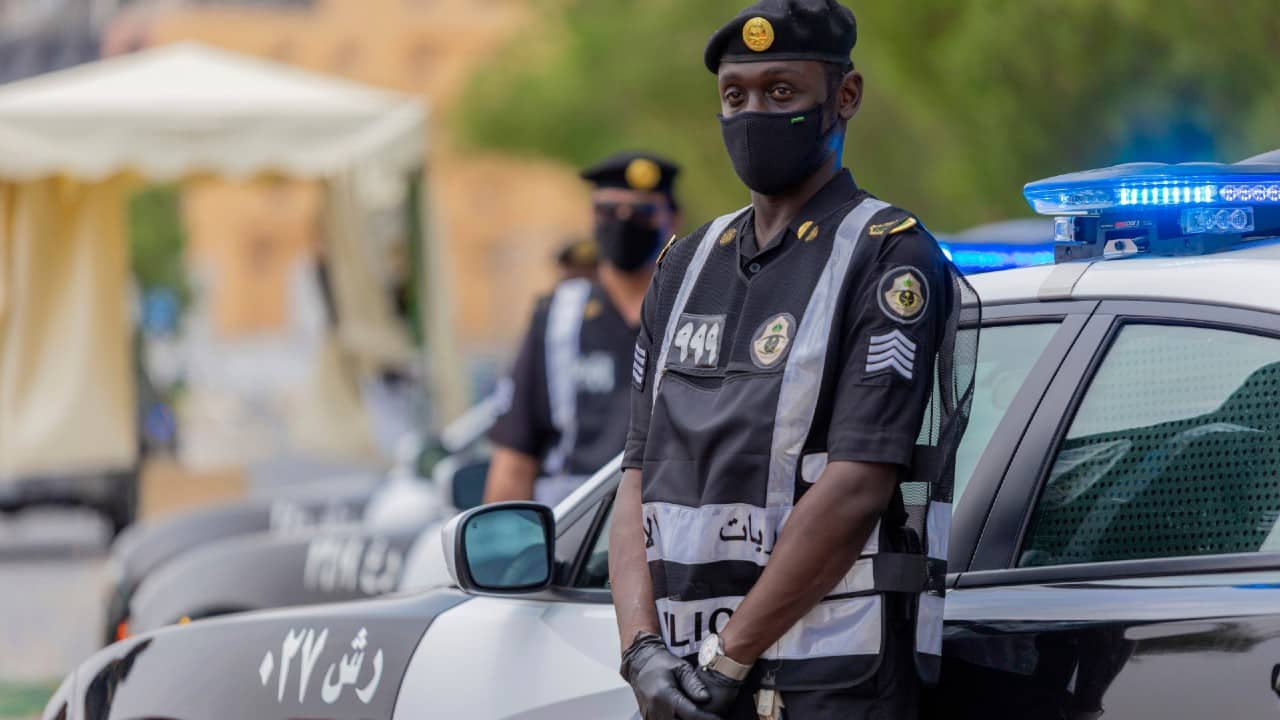 Policemen wearing gloves and face masks to help prevent the spread of the coronavirus, provide security for pilgrims, in Mecca, Saudi Arabia, July 26. (Saudi Ministry of Media via AP)