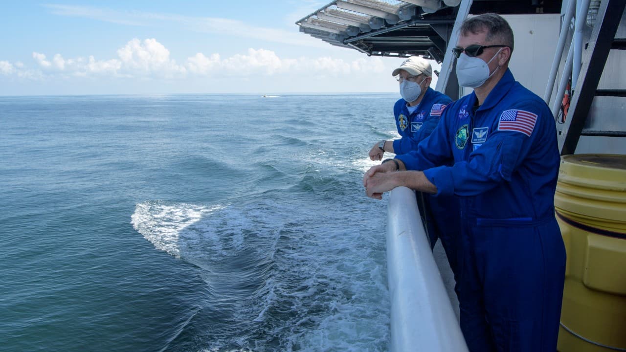 NASA Chief Astronaut Pat Forrester, left, and NASA astronaut and Crew Recovery Chief Shane Kimbrough, along with other NASA and SpaceX support teams onboard the SpaceX GO Navigator recovery ship, prepare for the landing of the SpaceX Crew Dragon Endeavour spacecraft with NASA astronauts Robert Behnken and Douglas Hurley onboard, August 2, in the Gulf of Mexico off the coast of Pensacola. (Bill Ingalls/NASA via AP) NASA Chief Astronaut Pat Forrester, left, and NASA astronaut and Crew Recovery Chief Shane Kimbrough, along with other NASA and SpaceX support teams onboard the SpaceX GO Navigator recovery ship, prepare for the landing of the SpaceX Crew Dragon Endeavour spacecraft with NASA astronauts Robert Behnken and Douglas Hurley onboard, August 2, in the Gulf of Mexico off the coast of Pensacola. (Bill Ingalls/NASA via AP)