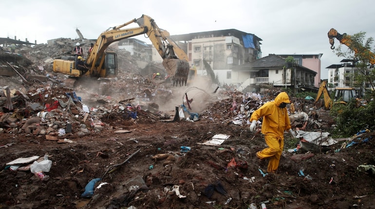 Rescue workers search for survivors in the debris after a five-story building collapsed in Mahad in Raigad. (Image: Reuters)