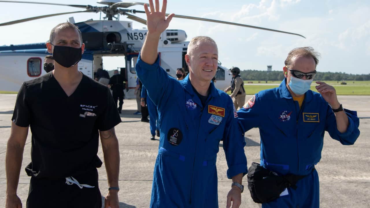 NASA astronaut Douglas Hurley waves to onlookers as he boards a plane at Naval Air Station Pensacola, August 2. (Bill Ingalls/NASA via AP) NASA astronaut Douglas Hurley waves to onlookers as he boards a plane at Naval Air Station Pensacola, August 2. (Bill Ingalls/NASA via AP)