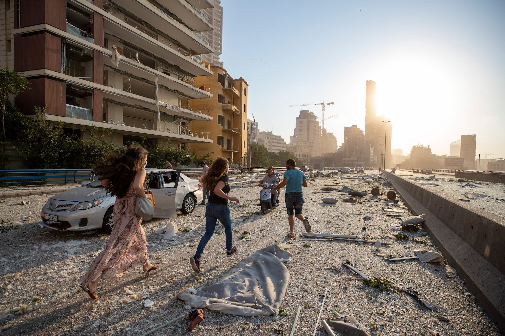 People run in the aftermath of a massive explosion in Beirut, Lebanon, Tuesday, Aug. 4, 2020. (AP Photo/Hassan Ammar)