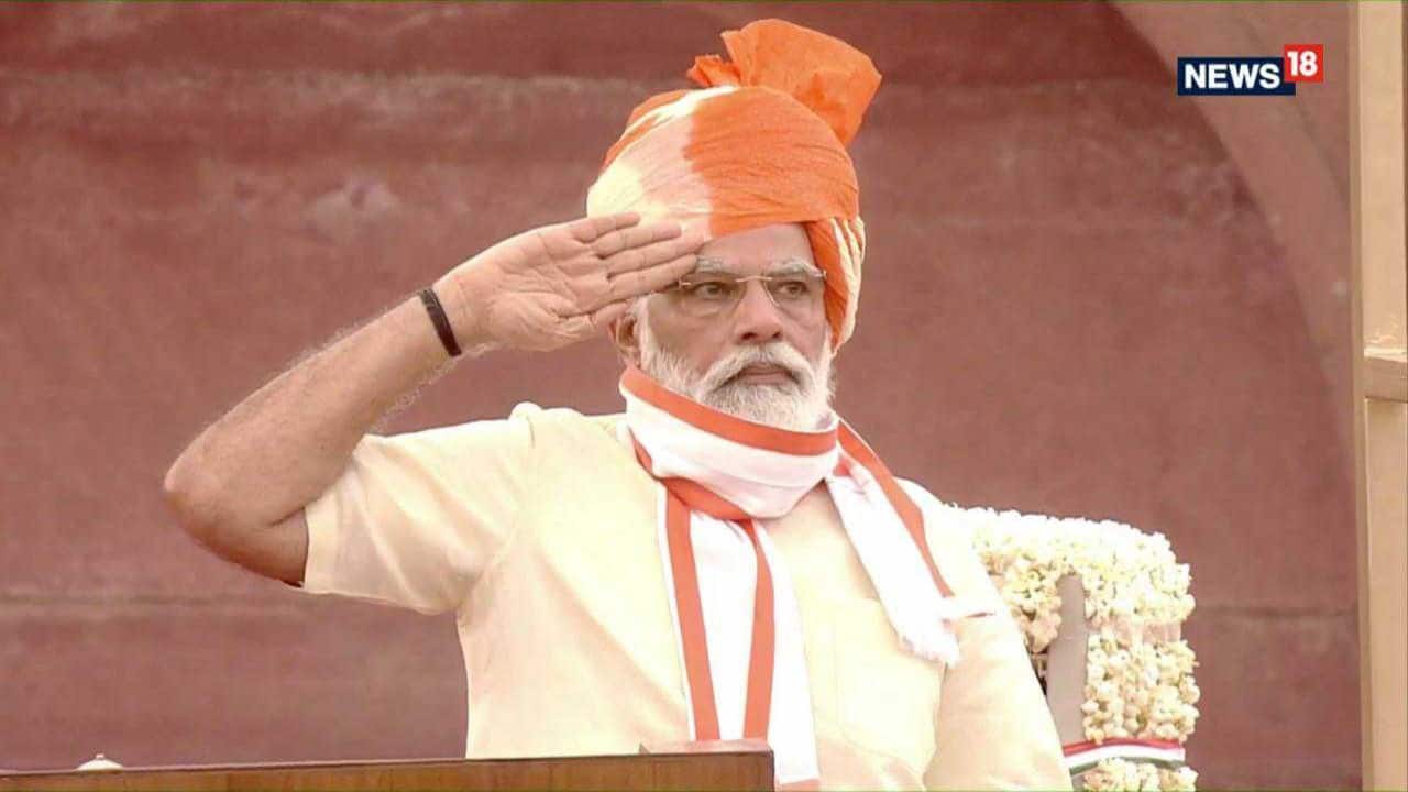 PM Modi salutes the tri colour. (Image: News18)