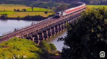 Scenic view of train traversing over the shimmering Aghanashini River near Kumta railway station in Konkan railway. (Image: Twitter @RailMinIndia)