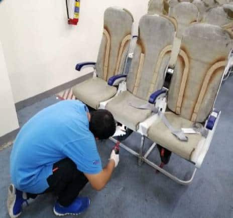 Staff at Epsilon's facility inspecting aircraft seats