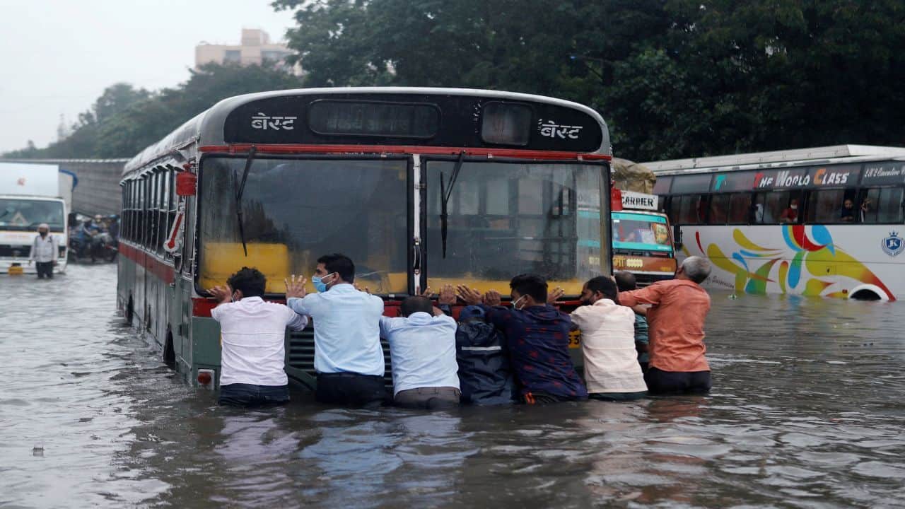 A vendor stands in a flooded flower market following heavy monsoon rains. (Image: AFP)