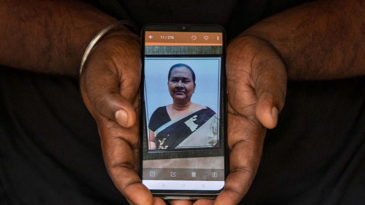 Sanjib Chatterjee, 34, shows a picture on his phone of his mother Chitra Chatterjee, 62, a housewife, who died due to the COVID-19, as he poses for a photograph, in Kolkata, India, September 25. "The last memory was when she was diagnosed with COVID-19," said Chatterjee. "We came to know about it after we received a call from the health department saying that she needed to visit the hospital," she added. "I hugged her and told her don't worry and we will be back soon." (Image: Reuters) Sanjib Chatterjee, 34, shows a picture on his phone of his mother Chitra Chatterjee, 62, a housewife, who died due to the COVID-19, as he poses for a photograph, in Kolkata, India, September 25. "The last memory was when she was diagnosed with COVID-19," said Chatterjee. "We came to know about it after we received a call from the health department saying that she needed to visit the hospital," she added. "I hugged her and told her don't worry and we will be back soon." (Image: Reuters)