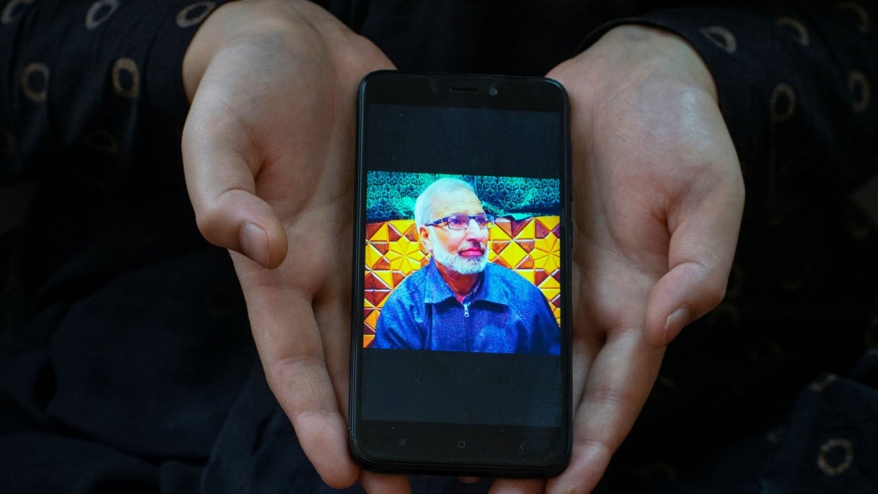 Khushboo, 26, a student, shows a picture on her phone of her father Shakeel Ahmad Baba, a government employee, who died due to the coronavirus disease, as she poses for a photograph, in Srinagar, September 24. "Our lives changed drastically after my father passed away, he was a loving father, a decision maker. He died because of improper healthcare facilities in the hospital. He would have survived had there been a proper oxygen supply in the hospital. A day before his death I spoke to him on the phone and he told me to pray for him and the next day he passed away. His death left a great void in our entire family," said Khushboo. (Image: Reuters) Khushboo, 26, a student, shows a picture on her phone of her father Shakeel Ahmad Baba, a government employee, who died due to the coronavirus disease, as she poses for a photograph, in Srinagar, September 24. "Our lives changed drastically after my father passed away, he was a loving father, a decision maker. He died because of improper healthcare facilities in the hospital. He would have survived had there been a proper oxygen supply in the hospital. A day before his death I spoke to him on the phone and he told me to pray for him and the next day he passed away. His death left a great void in our entire family," said Khushboo. (Image: Reuters)