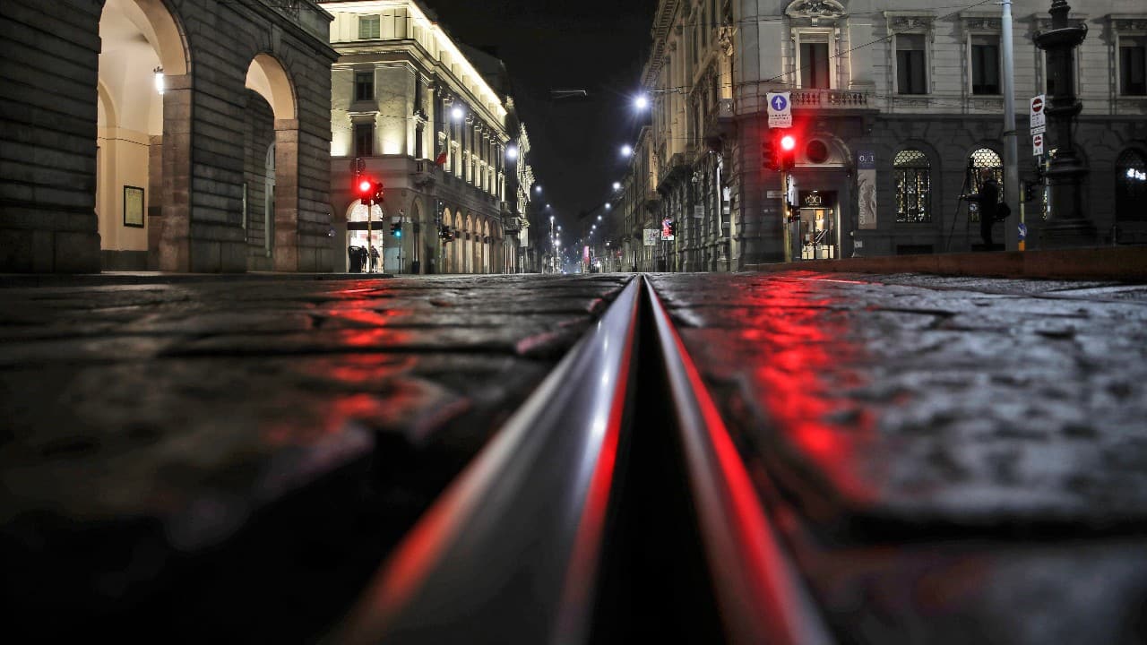After 11 p.m., Milan is a ghost town. The piazzas are the streets and quiet. An empty street is lit by street lights in Milan, northern Italy, October 25. AP)