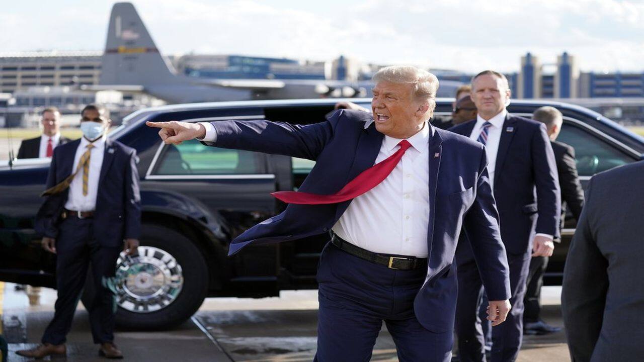 President Donald Trump gestures to supporters as he arrives at Minneapolis Saint Paul International Airport, Wednesday, September 30, 2020, in Minneapolis. (AP Photo)
