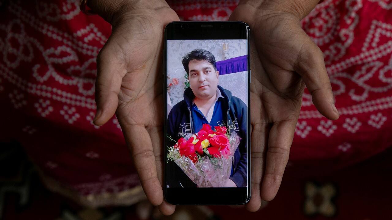 Abida Begum, 55, a housewife, shows a picture on her phone of her son-in-law Luqman Ahmed, a factory worker, who died due to the COVID-19, as she poses for a photograph, in New Delhi, India, September 26. "My son-in law was a good husband, a good father. He is gone too early. A lack of medical facilities killed him. He would have survived had there been proper medical care in hospitals. I appeal the government to ensure that they have good medical facilities in hospitals for the poor like us, so that people survive this pandemic," Begum said. (Image: Reuters) Abida Begum, 55, a housewife, shows a picture on her phone of her son-in-law Luqman Ahmed, a factory worker, who died due to the COVID-19, as she poses for a photograph, in New Delhi, India, September 26. "My son-in law was a good husband, a good father. He is gone too early. A lack of medical facilities killed him. He would have survived had there been proper medical care in hospitals. I appeal the government to ensure that they have good medical facilities in hospitals for the poor like us, so that people survive this pandemic," Begum said. (Image: Reuters)