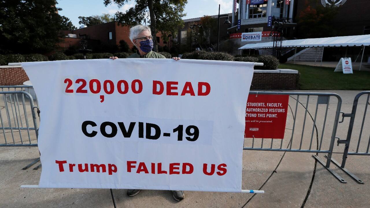 Tom Moran, a school bus driver from Fenton, Michigan, holds a sign outside the Curb Event Center, the site of second and final debate between 2020 U.S. presidential candidates President Donald Trump and Democratic nominee Joe Biden on October 22 at Belmont University in Nashville, Tennessee, U.S., October 21. (Image: Reuters)