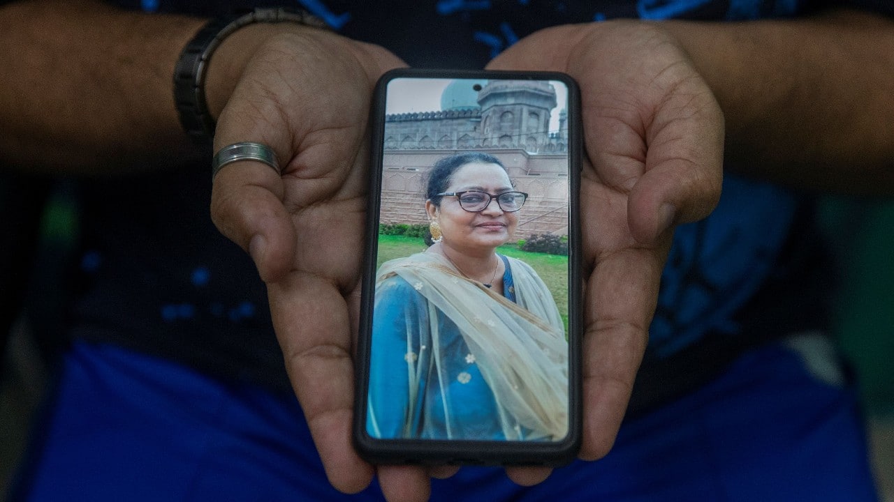 Nadeem Akhtar, a social worker, shows a picture on his phone of his sister Shabana Ahmed, 52, an architect, who died due to the coronavirus, as he poses for a photograph, in New Delhi, India, September 24. "What really upsets me more than the healthcare system was the behaviour of society," Akhtar said. "My sister's neighbourhood boycotted her family. There was no emotional or moral support even after her death. Society failed us." (Image: Reuters) Nadeem Akhtar, a social worker, shows a picture on his phone of his sister Shabana Ahmed, 52, an architect, who died due to the coronavirus, as he poses for a photograph, in New Delhi, India, September 24. "What really upsets me more than the healthcare system was the behaviour of society," Akhtar said. "My sister's neighbourhood boycotted her family. There was no emotional or moral support even after her death. Society failed us." (Image: Reuters)