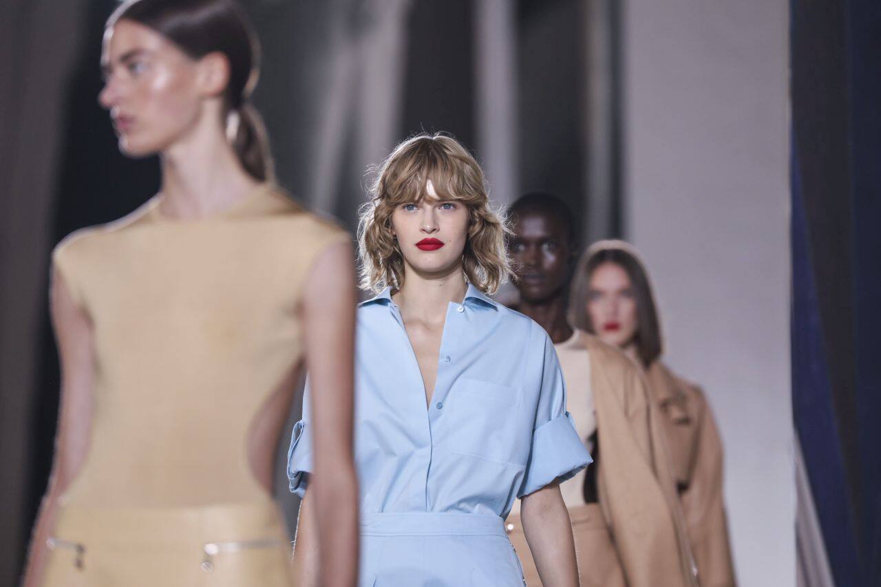 There was also some design flair, such as a loose marigold yellow pantsuit with a fun gargantuan peplum. Wearable was the season’s priority. (Source: AP News)