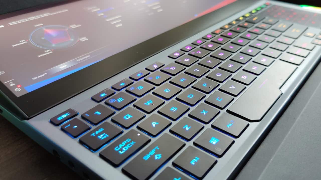 As with all top-end Zephyrus notebooks, the keyboard on the Duo 15 has been shifted to the bottom. The keyboard positioning doesn't make using it comfortably over prolonged periods, but the palm rest really helps here. The keys travel fairly deep and do offer a tactile feel while typing and gaming while spacing between them is just about right. The Zephyrus Duo 15 also features per-key RGB lighting as opposed to the zonal lighting. The trackpad is shifted to the right of the keyboard and doubles as a number pad. The trackpad takes a little getting used to but works quite well. And let's not forget that you do get a gaming mouse as well. As with all top-end Zephyrus notebooks, the keyboard on the Duo 15 has been shifted to the bottom. The keyboard positioning doesn't make using it comfortably over prolonged periods, but the palm rest really helps here. The keys travel fairly deep and do offer a tactile feel while typing and gaming while spacing between them is just about right. The Zephyrus Duo 15 also features per-key RGB lighting as opposed to the zonal lighting. The trackpad is shifted to the right of the keyboard and doubles as a number pad. The trackpad takes a little getting used to but works quite well. And let's not forget that you do get a gaming mouse as well.