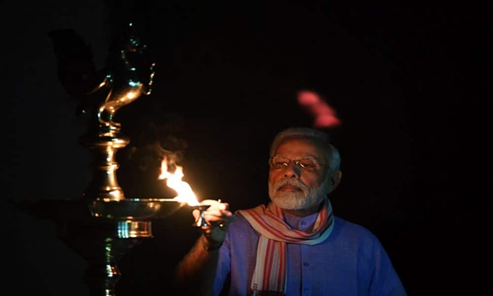 PM Modi lights up lamp at his residence during 9 Baje 9 minutes to show solidarity in fight against coronavirus. PM Modi lights up lamp at his residence during 9 Baje 9 minutes to show solidarity in fight against coronavirus.