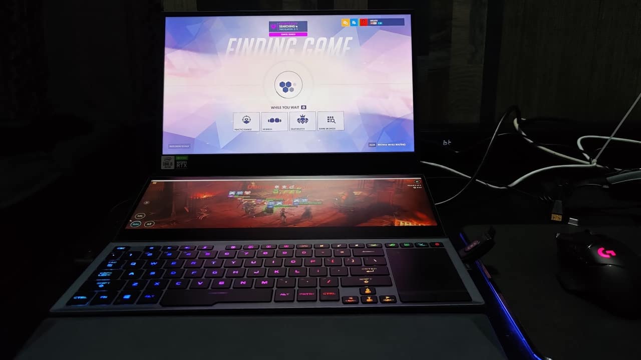 Before we get to the main display, let's start off with the second screen, titled the ScreenPad Plus. This is the second iteration of Asus' ScreenPad Plus technology, and it goes without saying that things have gotten much better. When you turn on the laptop, you are treated to a blueprint futuristic flying city on the secondary display. ScreenPad Plus allows you to open up to three applications simultaneously. Apps are easy to drag and drop in the second screen, while you can easily switch apps between the two panels with a push of a button. Not much has changed from the ScreenPad Plus on the ZenBook Pro Duo. But the biggest and most important change here is that the second screen is now elevated, which massively increases its utility over the previous version. Before we get to the main display, let's start off with the second screen, titled the ScreenPad Plus. This is the second iteration of Asus' ScreenPad Plus technology, and it goes without saying that things have gotten much better. When you turn on the laptop, you are treated to a blueprint futuristic flying city on the secondary display. ScreenPad Plus allows you to open up to three applications simultaneously. Apps are easy to drag and drop in the second screen, while you can easily switch apps between the two panels with a push of a button. Not much has changed from the ScreenPad Plus on the ZenBook Pro Duo. But the biggest and most important change here is that the second screen is now elevated, which massively increases its utility over the previous version.