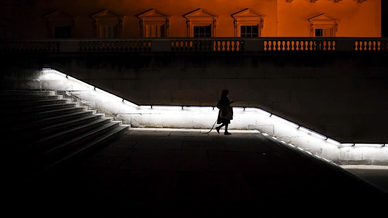 All non-essential venues — which in England includes pubs, restaurants, hairdressers, golf courses, gyms, swimming pools, entertainment places and stores selling items like books, clothing and sneakers — must close on November 5 until at least December 2. A woman walks down steps from The Mall, in London, November 4. (Image: AP)