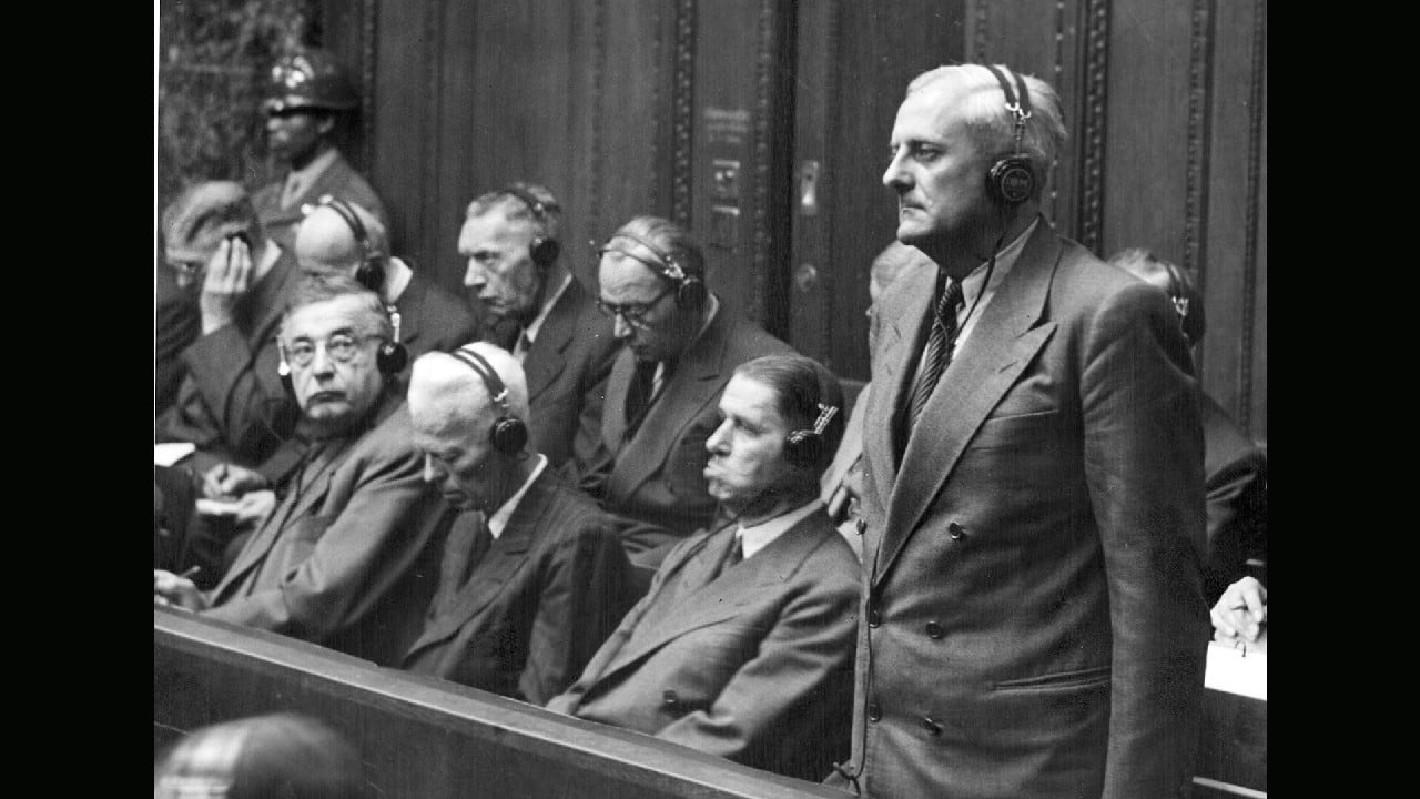 Otto Ambros, standing, listens to his verdict of eight years in prison by the U.S. Military Tribunal in Nuremberg, Germany, July 30, 1948. Ambros was chief of the chemical warfare Committee of the Ministry for Araments and War Production and manager of several of the I.G. Farben's plants, including the Auschwitz plant. (Image: AP) Otto Ambros, standing, listens to his verdict of eight years in prison by the U.S. Military Tribunal in Nuremberg, Germany, July 30, 1948. Ambros was chief of the chemical warfare Committee of the Ministry for Araments and War Production and manager of several of the I.G. Farben's plants, including the Auschwitz plant. (Image: AP)