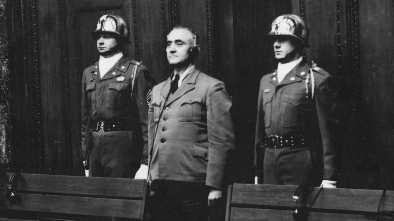 Defendant Gottlob Berger, former chief of the SS head office, is sentenced to 25 years imprisonment on April 14, 1949, flanked by Sgt. 1st class Thomas H. Andress from Palestine, Texas, member of the honor guard 16th inf., left, and a not identified honor guard in Nuremberg, Germany. (Image: AP) Defendant Gottlob Berger, former chief of the SS head office, is sentenced to 25 years imprisonment on April 14, 1949, flanked by Sgt. 1st class Thomas H. Andress from Palestine, Texas, member of the honor guard 16th inf., left, and a not identified honor guard in Nuremberg, Germany. (Image: AP)