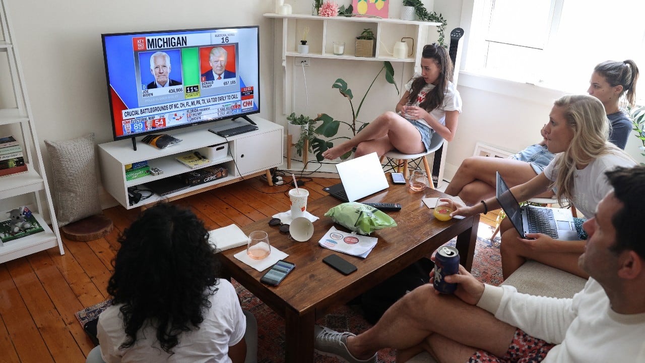 U.S. citizens living abroad watch results come in for the U.S. presidential election between President Donald Trump and Democratic presidential nominee Joe Biden at a home watch party in Sydney, Australia, November 4. (Image: Reuters) 