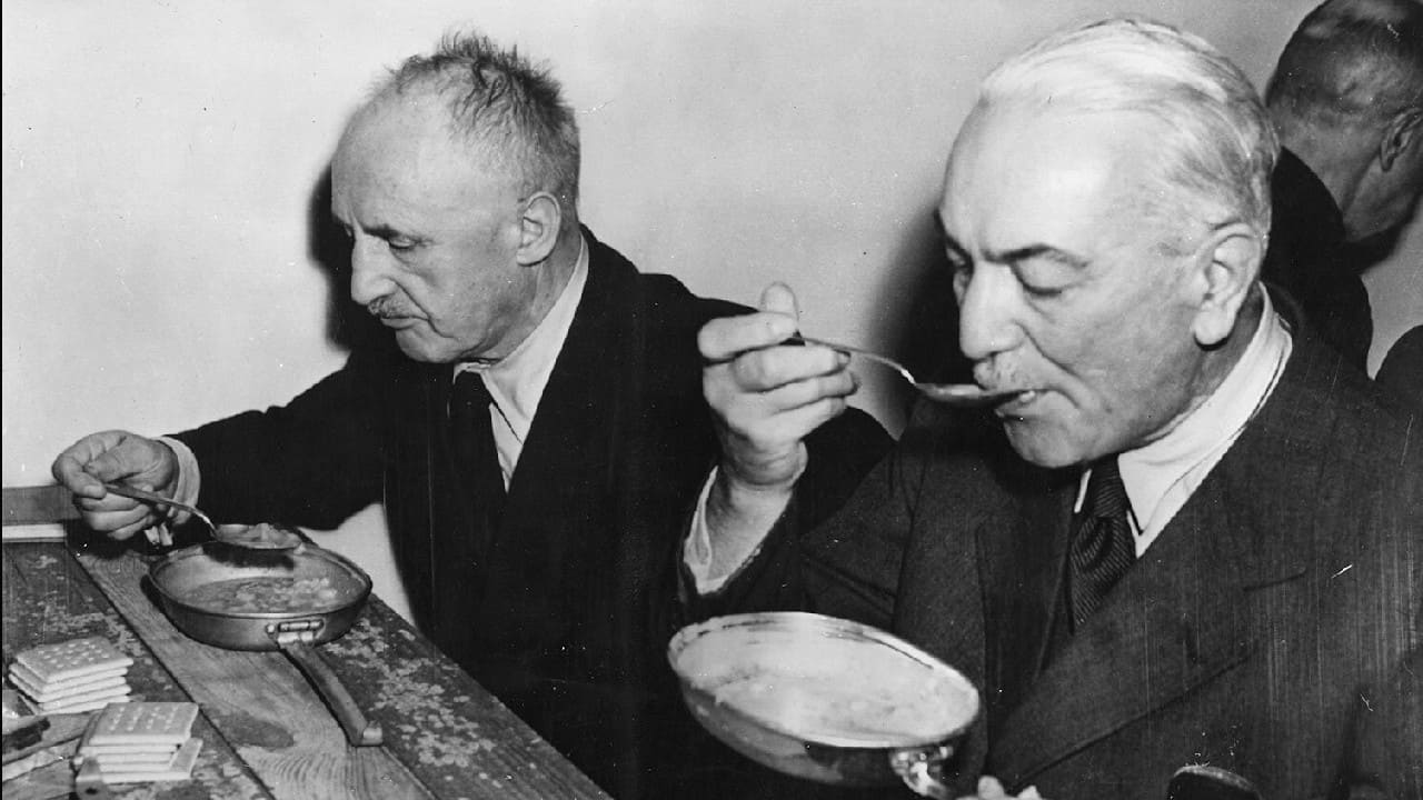 Former Foreign Minister of the German Reich, Dr. Konstantin von Neurath, right, and Julius Streicher eating their lunches from US American Army mess tins on a bare board table, in the Palace of Justice, in Nuremberg, Germany, November 29, 1945. Both are accused of crimes of war. (Image: AP) Former Foreign Minister of the German Reich, Dr. Konstantin von Neurath, right, and Julius Streicher eating their lunches from US American Army mess tins on a bare board table, in the Palace of Justice, in Nuremberg, Germany, November 29, 1945. Both are accused of crimes of war. (Image: AP)