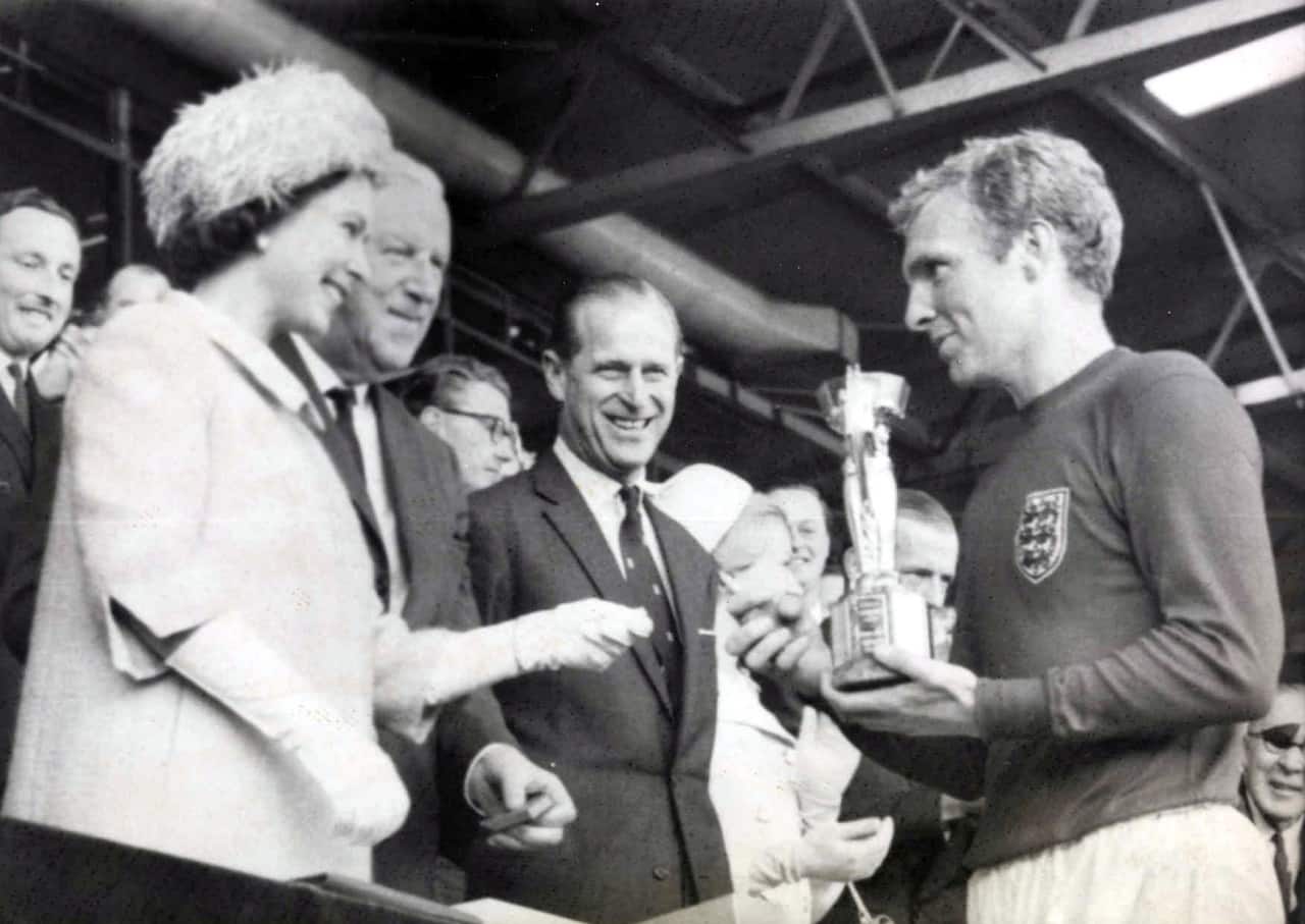 Queen Elizabeth II presenting the Jules Rimet trophy to 1966 World Cup winning England captain Bobby Moore. 