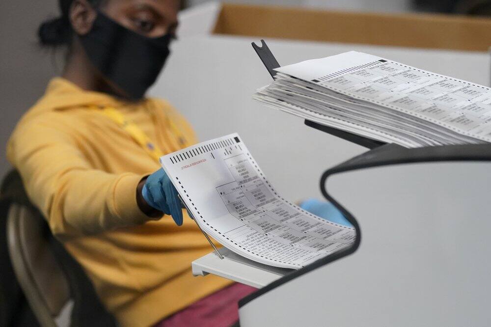 A county election worker scans mail-in ballots at a tabulating area at the Clark County Election Department, Thursday, Nov. 5, 2020, in Las Vegas. (Image: AP Photo)