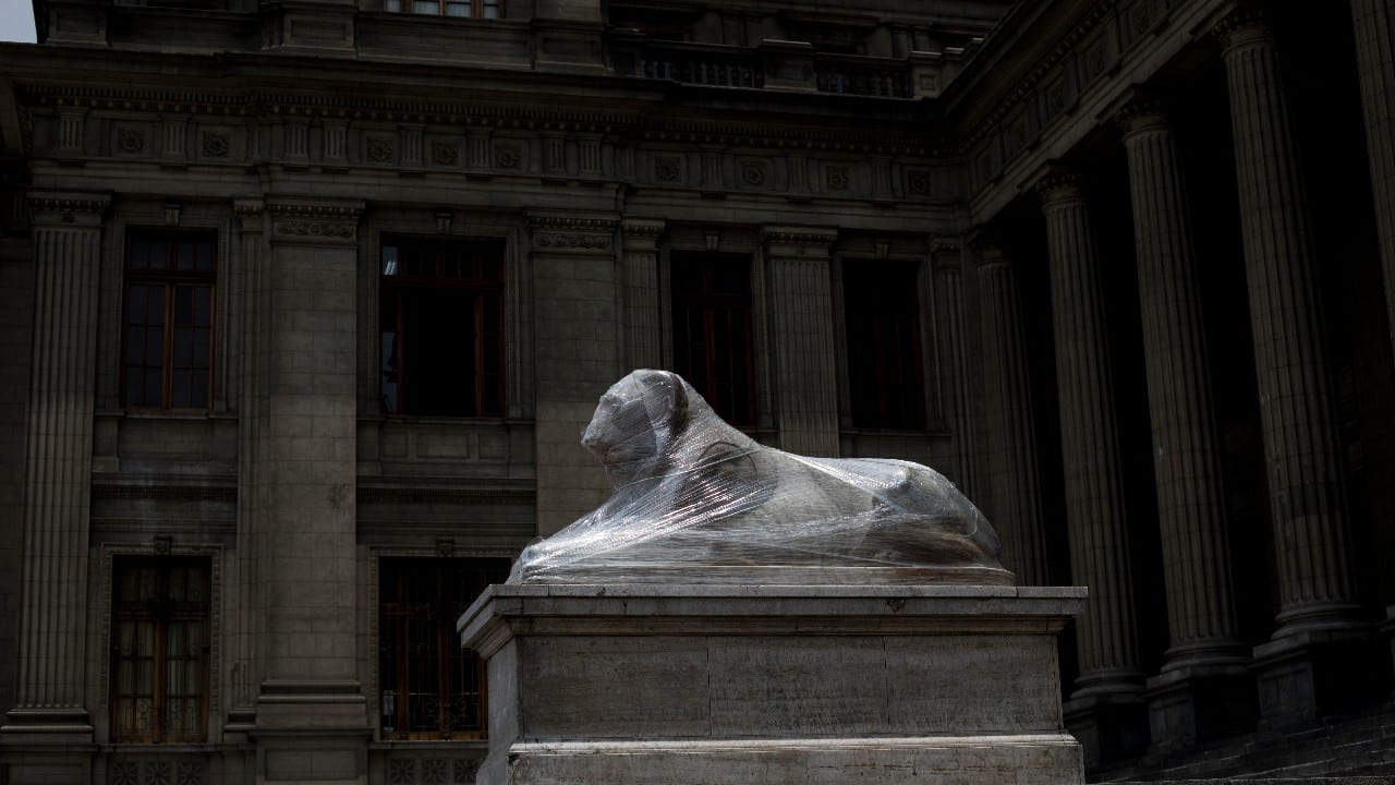 The statue of a lion that sits at the main entrance of the Palace of Justice is wrapped in plastic, in Lima, Peru, December 1. (Image: AP) 