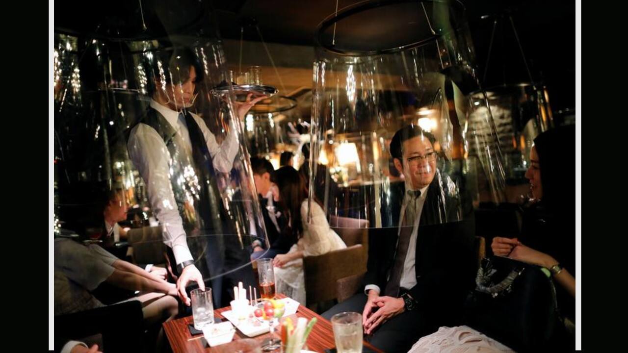 Goldfish bowl-like acrylic screens installed as part of new social distancing measures at Jazz Lounge Encounter, a night club for seeking encounters, in Tokyo's Ginza district, Japan, August 6. (Image: Reuters) Goldfish bowl-like acrylic screens installed as part of new social distancing measures at Jazz Lounge Encounter, a night club for seeking encounters, in Tokyo's Ginza district, Japan, August 6. (Image: Reuters)