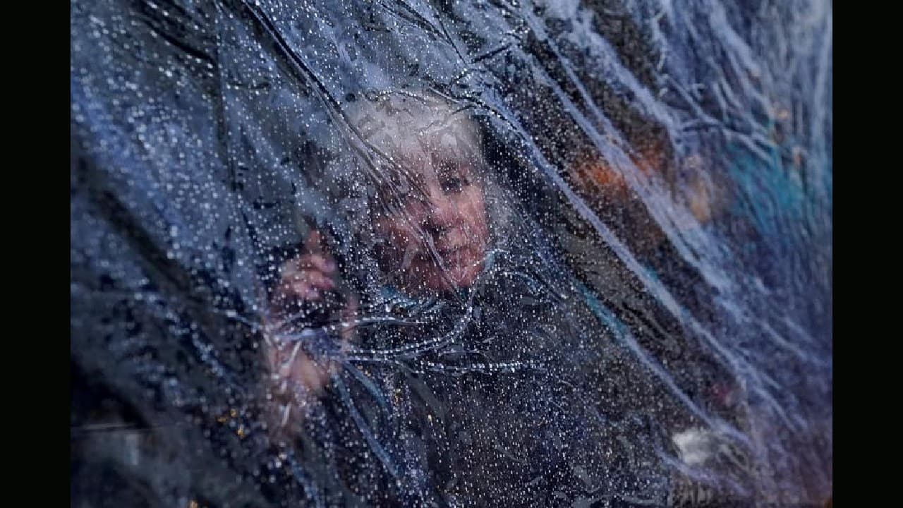 Raindrops are seen on outdoor protective plastic sheeting surrounding a woman on her phone at a cafe dining area in Galway, Ireland, October 20. (Image: Reuters) Raindrops are seen on outdoor protective plastic sheeting surrounding a woman on her phone at a cafe dining area in Galway, Ireland, October 20. (Image: Reuters)