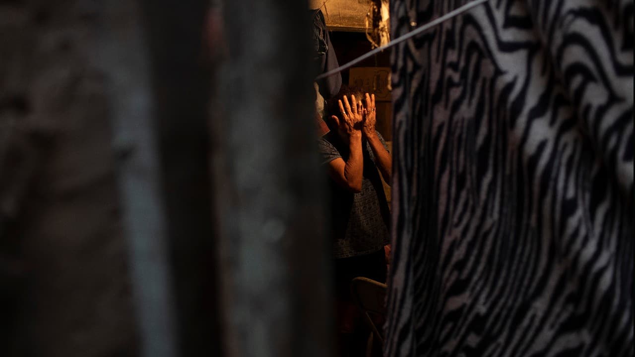 Maria Rita Dias dos Santos wipes tears after former inmates delivered free food to her home, as part of a nonprofit organization known as &quot;Eu sou Eu&quot; or &quot;I am me&quot; that gifts food to those struggling economically amid the new coronavirus pandemic in the Para-Pedro favela of Rio de Janeiro, Brazil, May 8. (Image: AP)