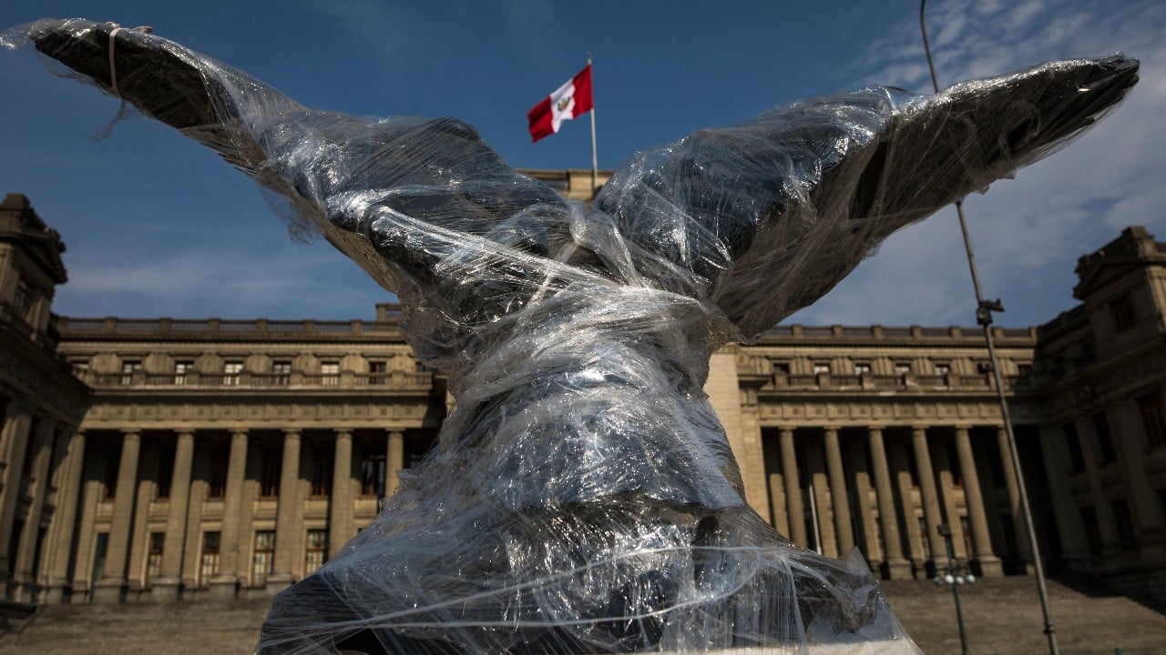 A sculpture of an eagle that sits in front of Justice Palace is wrapped in plastic, in Lima, Peru, November 21. More than three weeks after the first protest, monuments are still covered in plastic or fabric, although protests have faded in the capital. (Image: AP) 