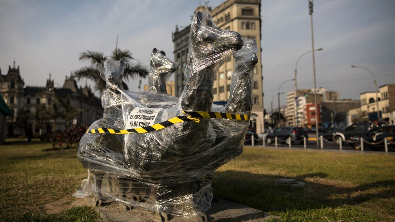 A bronze sculpture of four llamas is wrapped in plastic near the Palace of Justice in Lima, Peru, November 21. (Image: AP)