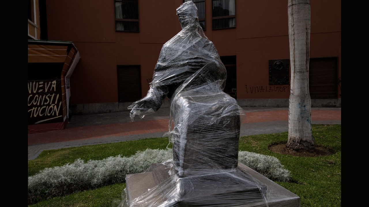 A statue of Peruvian theologian Jorge Dintilhac, founder of the Pontifical Catholic University of Peru, sits wrapped in plastic in Lima, December 1. (Image: AP)