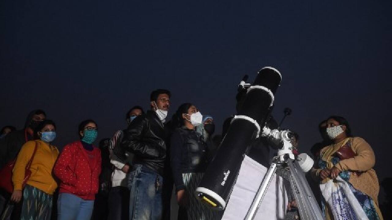 But hundreds of space fans also gathered in Kolkata to watch -- through a telescope at a technology museum in the city, or from surrounding rooftops and open areas. (Image: AFP)