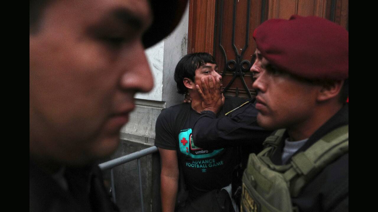 A supporter of Keiko Fujimori, the daughter of Peru's former President Alberto Fujimori and opposition leader, is held back by police officers outside a courtroom in Lima, Peru, January 28. A Peruvian judge ordered 15 months of preventive detention for Keiko Fujimori while she is investigated for alleged money laundering related to the Brazilian construction company Odebrecht. (Image: AP)