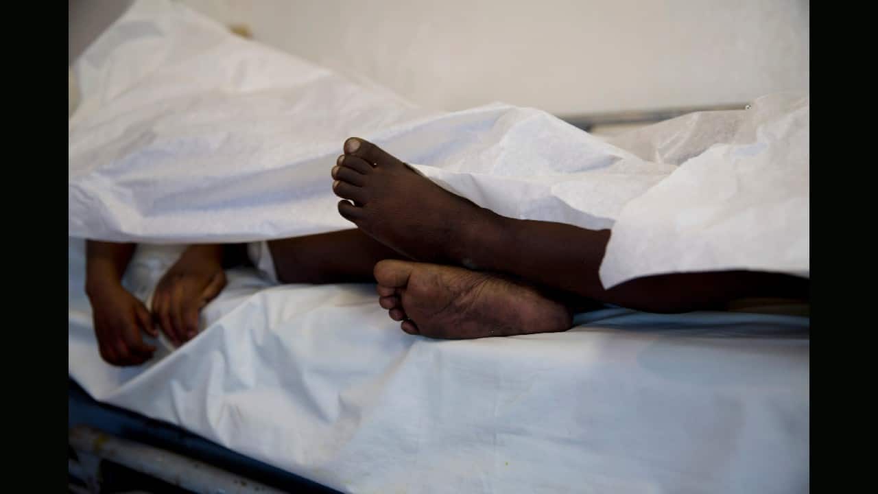 The feet and hands of children who died in a fire at the Orphanage of the Church of Bible Understanding extend beyond the sheet they lie under on a bed at Baptiste Mission Hospital in Kenscoff, on the outskirts of Port-au-Prince, Haiti, February 14. A fire swept through a Haitian children's home run by a Pennsylvania-based nonprofit group, killing 13 children. (Image: AP)