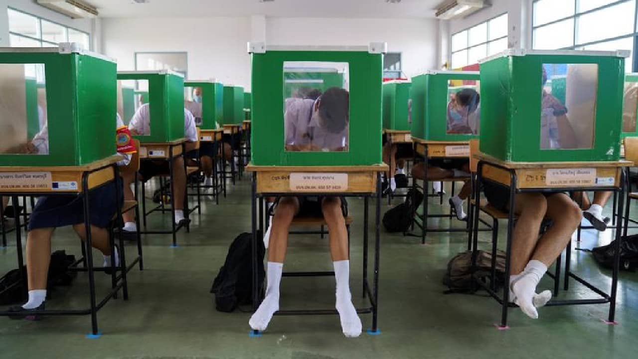 Students sit behind old ballot boxes repurposed into partitions as they attend class in Pathum Thani province, Thailand, July 1. (Image: Reuters) Students sit behind old ballot boxes repurposed into partitions as they attend class in Pathum Thani province, Thailand, July 1. (Image: Reuters)
