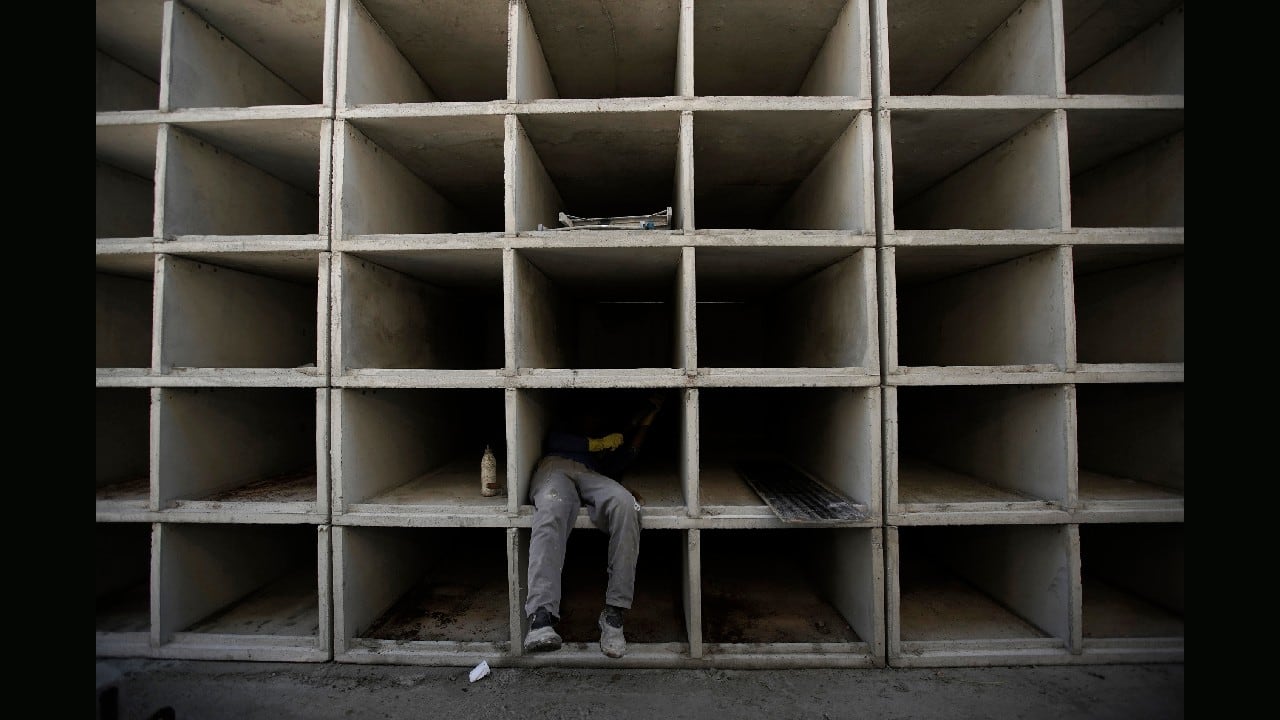 A worker builds niches at the Caju Cemetery in Rio de Janeiro, Brazil, April 20. There were already plans this year to create more tombs at Caju but the new coronavirus pandemic accelerated the construction. (Image: AP)