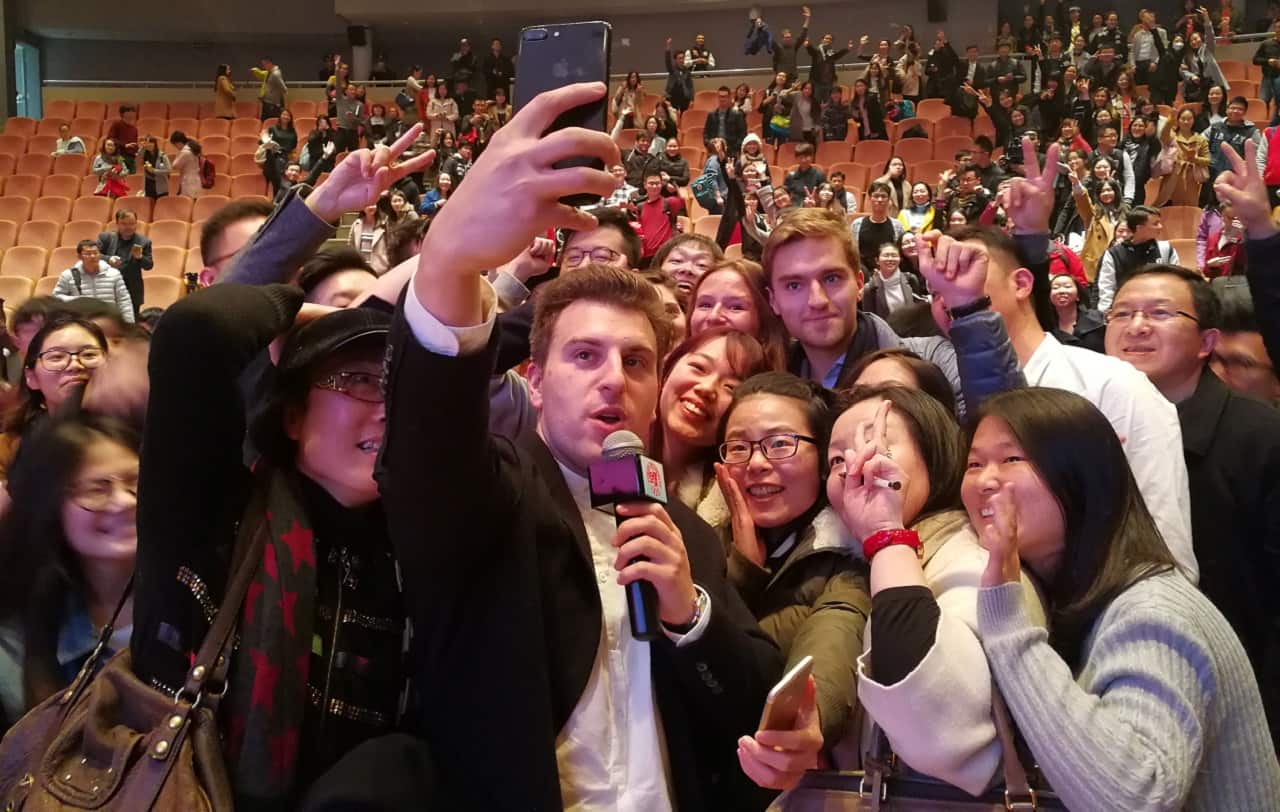 Airbnb Co-Founder and CEO Brian Chesky pose for selfie with students at Fudan University in Shanghai, China March 21, 2017. Picture taken March 21, 2017. REUTERS/Stringer 