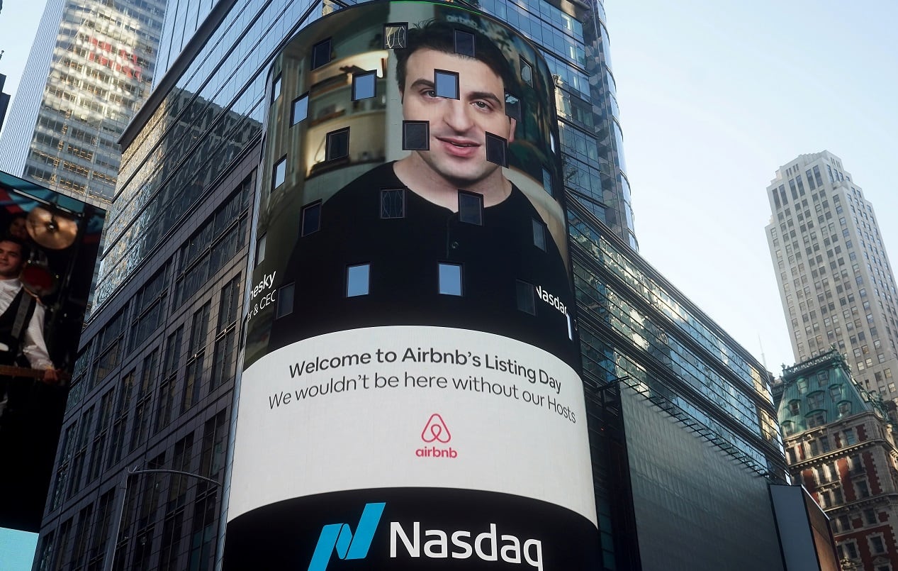 The NASDAQ market site displays an AirBnb sign featuring CEO Brian Chesky on their billboard on the day of their IPO in Times Square in the Manhattan borough of New York City, New York, U.S., December 10, 2020. REUTERS/Carlo Allegri 