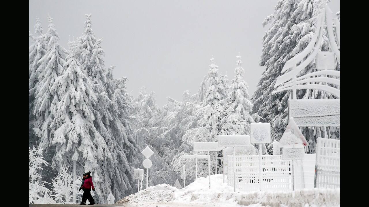 People cross a road in a snow covered landscape in Oberhof, Germany, January 7. (Image: AP/Matthias Schrader)