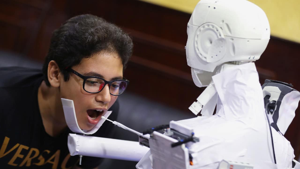 The remote-controlled robot that has been built by the Egyptian mechanical engineer, Mahmoud El komy, tests a boy for the coronavirus by running PCR tests, limiting exposure to suspected cases, during the global outbreak of the coronavirus disease (COVID-19), in Cairo, Egypt June 12, 2020. (Image: Reuters)