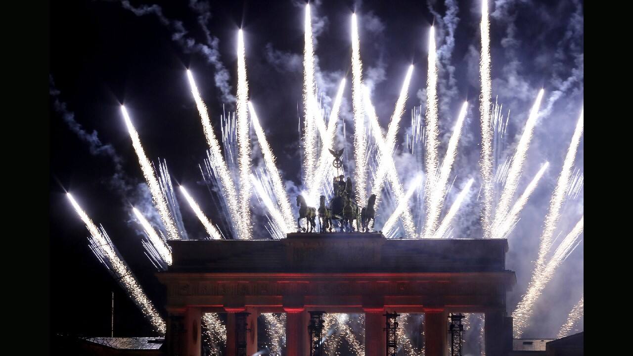 Fireworks light the sky during the New Year's celebrations at the Brandenburg Gate in Berlin, early on January 1. Germany began 2021 in a lockdown that appears certain to be extended beyond its current January 10 end date, with new coronavirus cases and deaths related to COVID-19 remaining at worryingly high levels. (Image: AP/Michael Sohn)