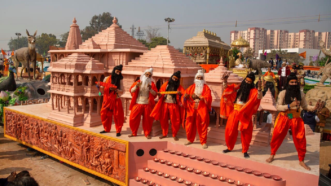 Folk artists dressed as Hindu holy men perform next to a replica of a proposed Rama temple as part of Uttar Pradesh state tableau during a press preview of the upcoming Republic Day parade, in New Delhi, January 22. (Image: AP)